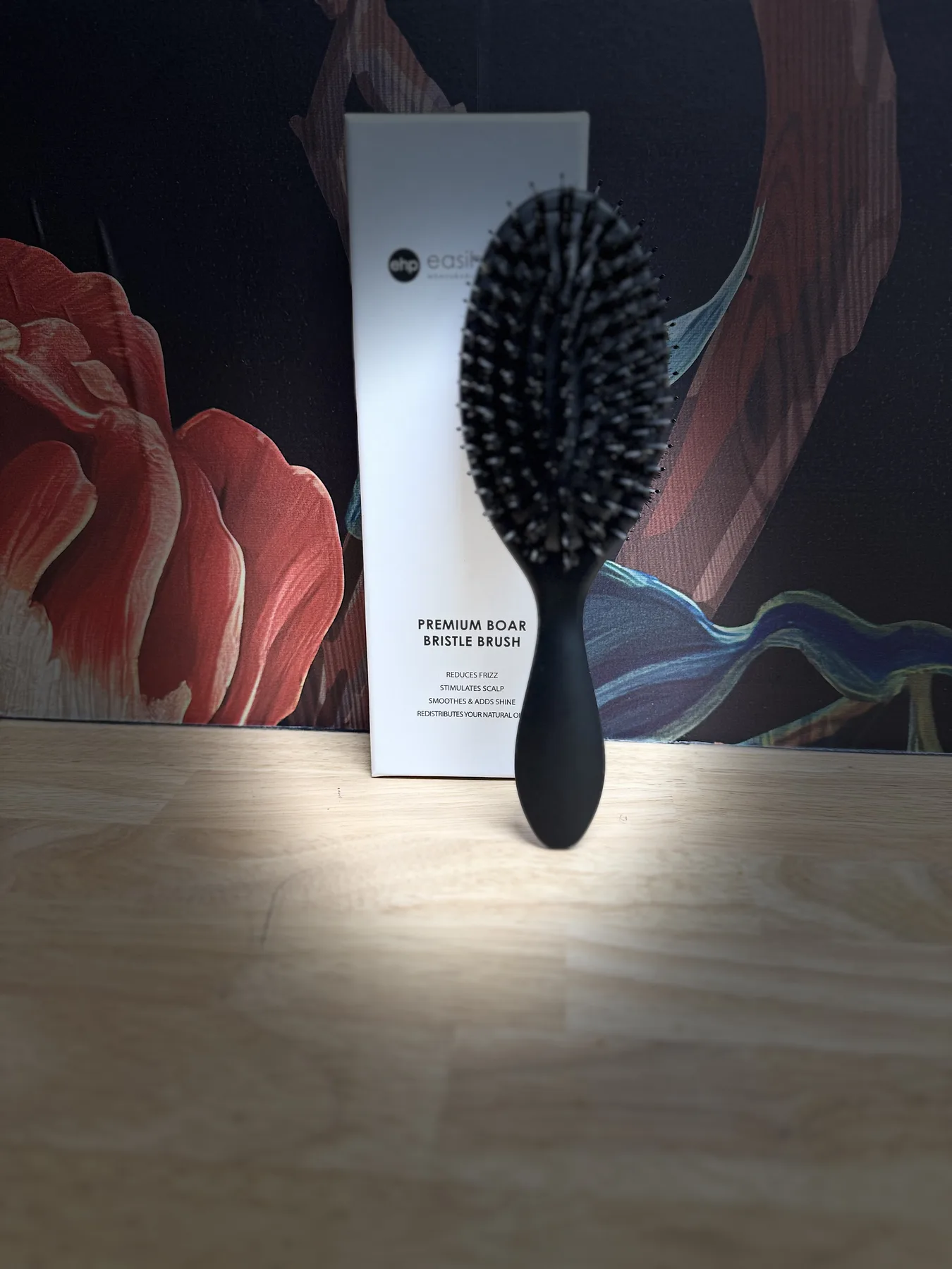Tape weft tools against the dark floral mural