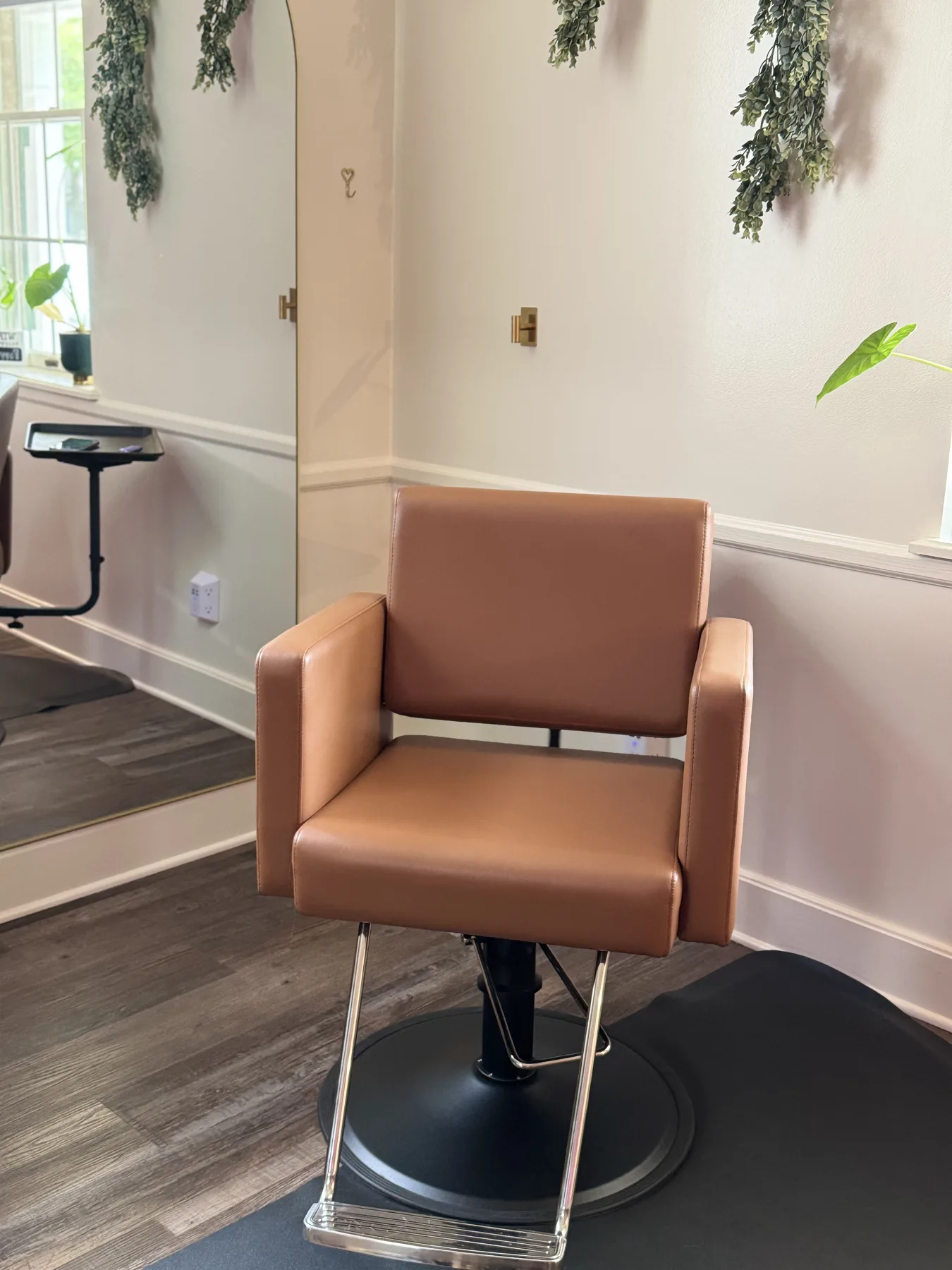 The cognac leather chair waiting by the mirror