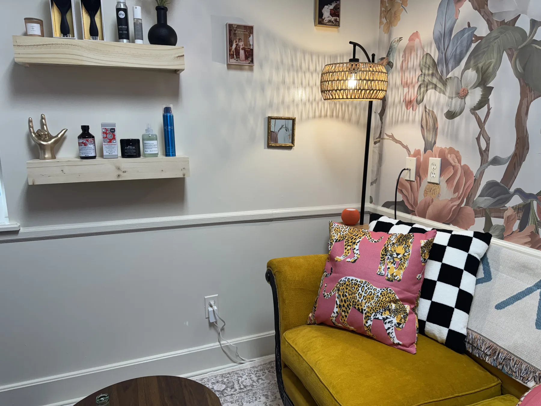 The consult lounge: mustard velvet sofa, wallpaper, rattan lamp